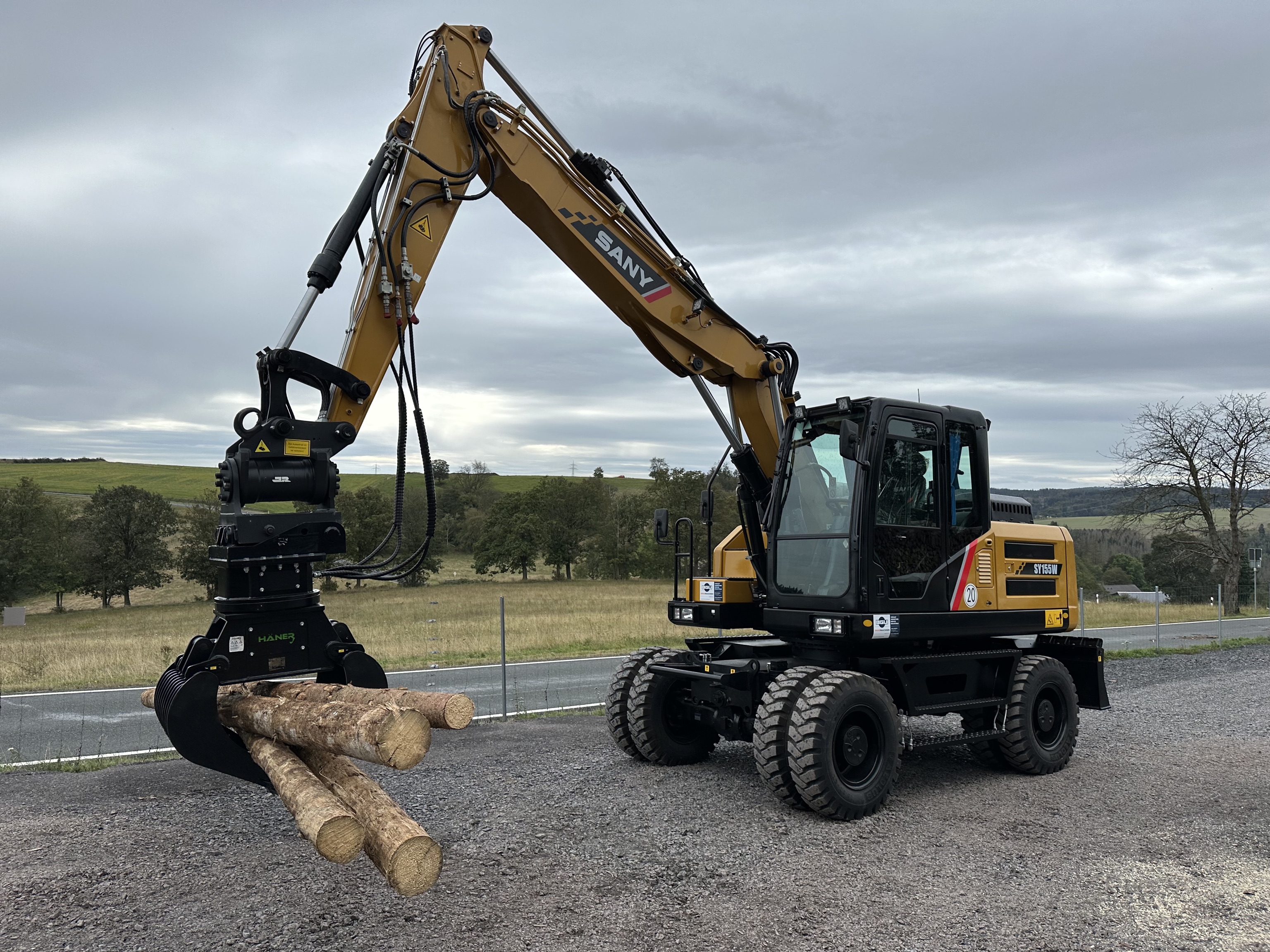 Bagger mit Holzgreifer beim Verladen